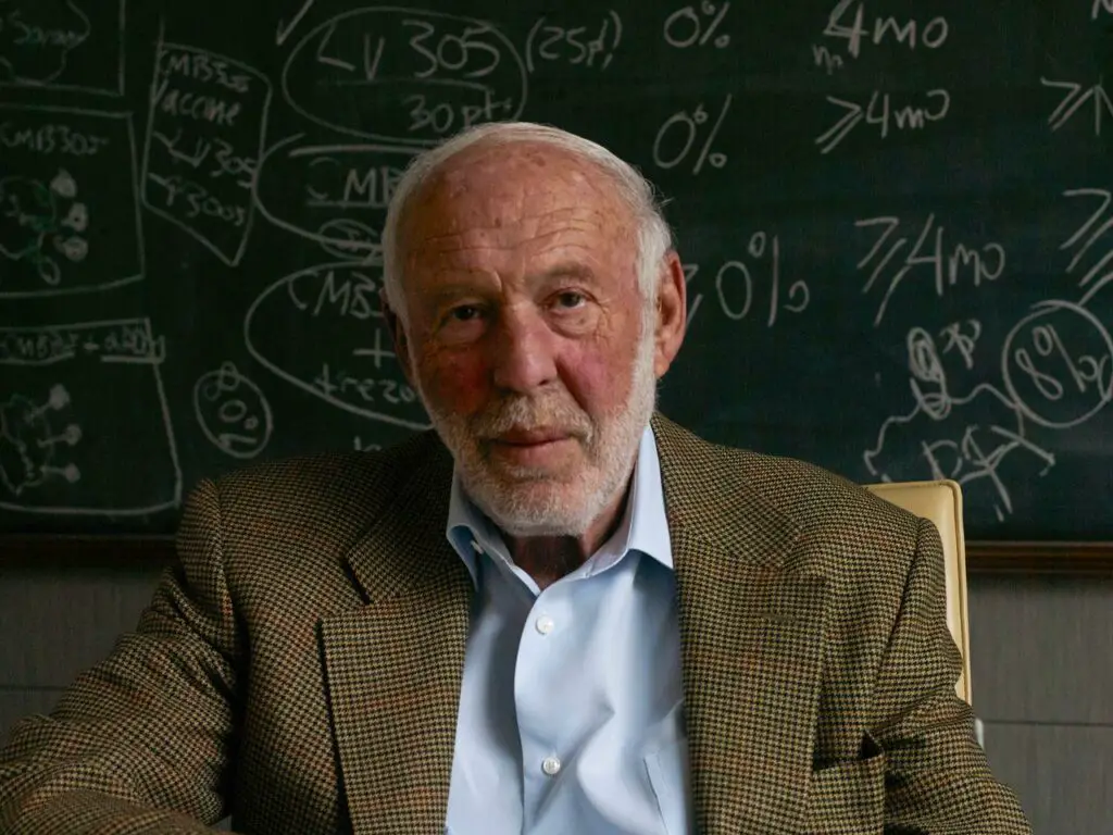 Jim Simons Sitting Infront of Blackboard